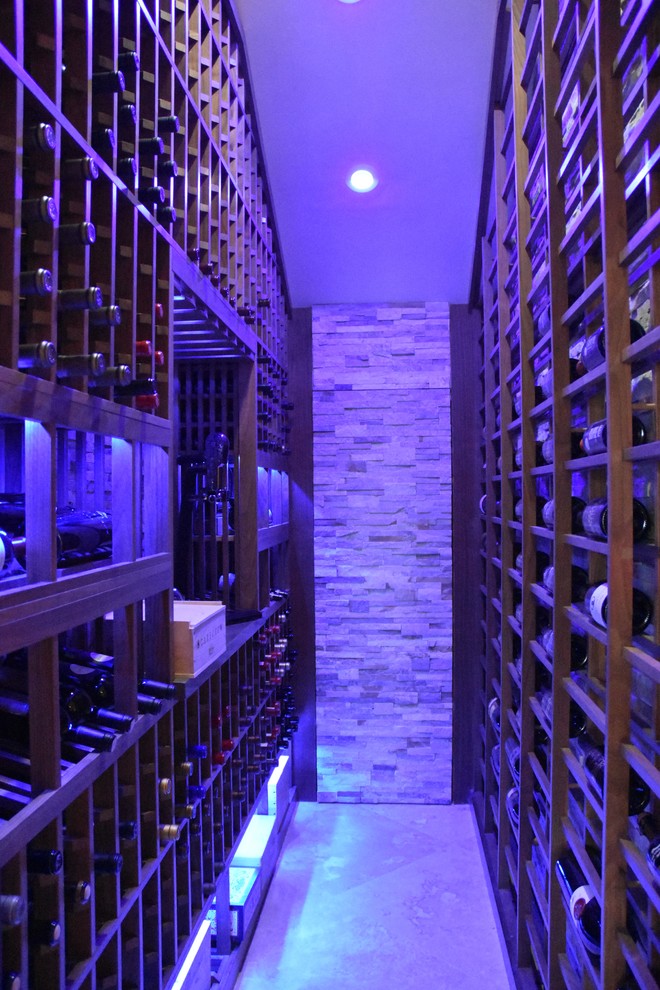 Mid-sized traditional wine cellar in Los Angeles with terra-cotta floors and display racks.