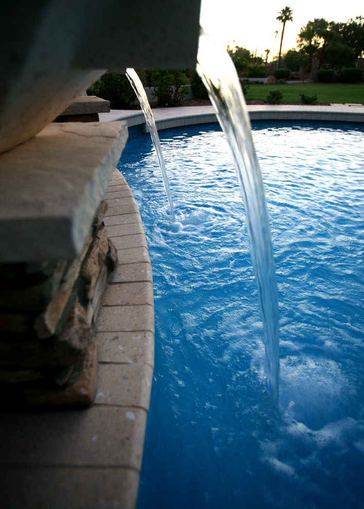 Pool house - mid-sized transitional backyard custom-shaped natural pool house idea in Phoenix with decking