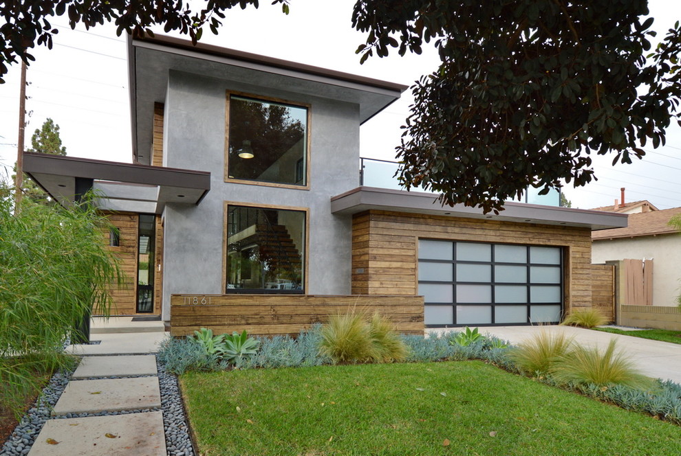Photo of a mid-sized modern two-storey grey exterior in Orange County with mixed siding and a flat roof.