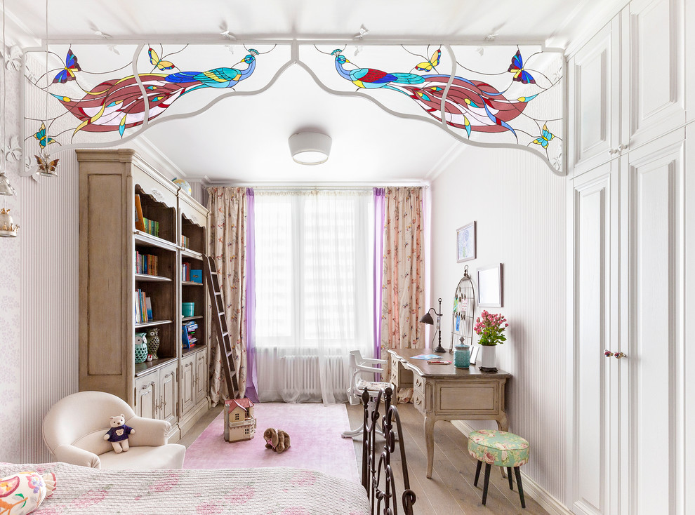 Design ideas for a traditional kids' study room for kids 4-10 years old and girls in Moscow with white walls and light hardwood floors.