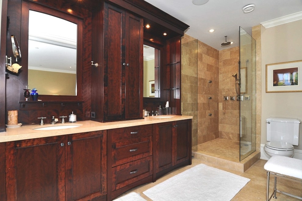 Design ideas for a large traditional master bathroom in Vancouver with a console sink, recessed-panel cabinets, dark wood cabinets, solid surface benchtops, an alcove shower, a one-piece toilet, multi-coloured tile, ceramic tile, beige walls and ceramic floors.