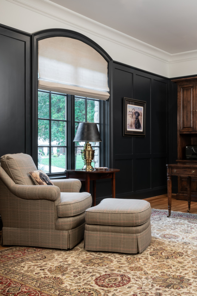 Inspiration for a large study room in St Louis with black walls, light hardwood floors, a freestanding desk and panelled walls.