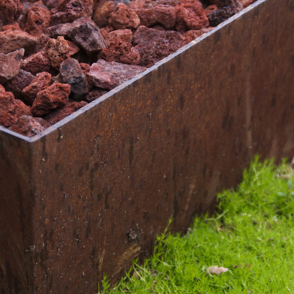 Cor Ten Steel Fire Pit With Lava Rock And Moss Groundcover