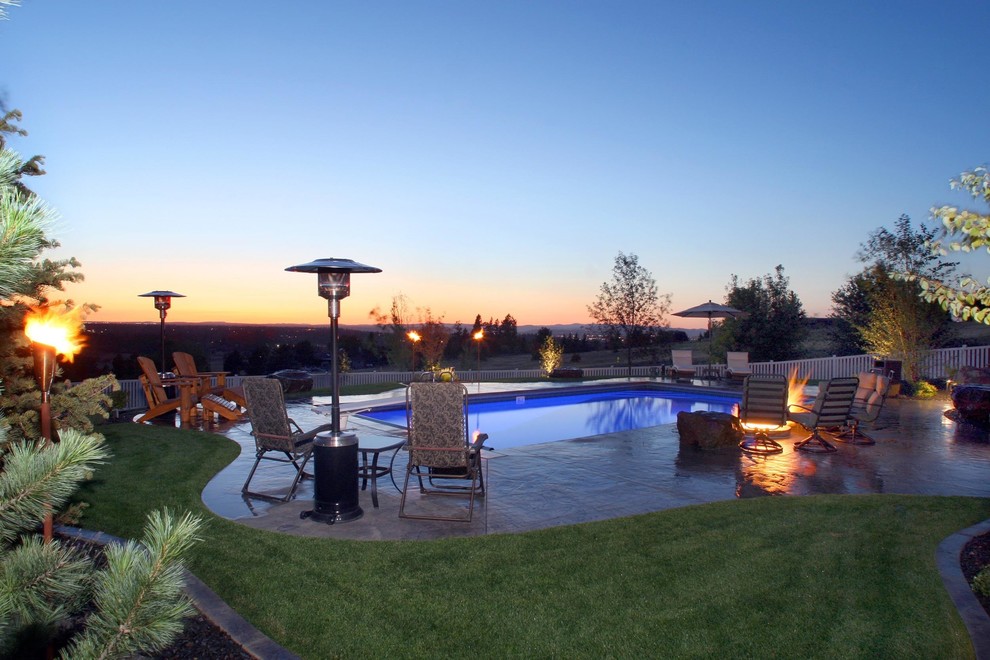 Photo of a mid-sized contemporary backyard rectangular lap pool in Seattle with a water feature and stamped concrete.