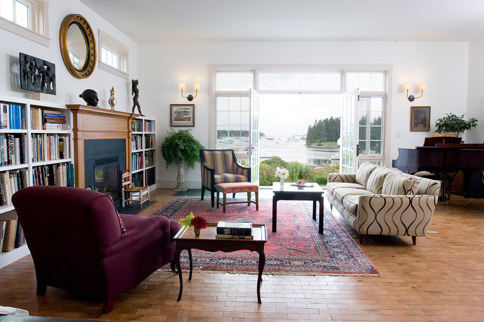 Inspiration for a traditional living room in Portland Maine with white walls, brick floors and a standard fireplace.