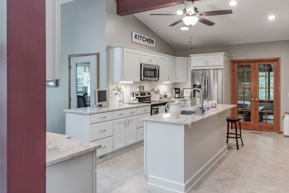 Inspiration for a mid-sized country u-shaped kitchen in Raleigh with a farmhouse sink, shaker cabinets, grey cabinets, granite benchtops, white splashback, subway tile splashback, stainless steel appliances and with island.