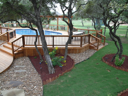 Another example of an above ground pool build into the landscaping and a deck working well with ground levels.