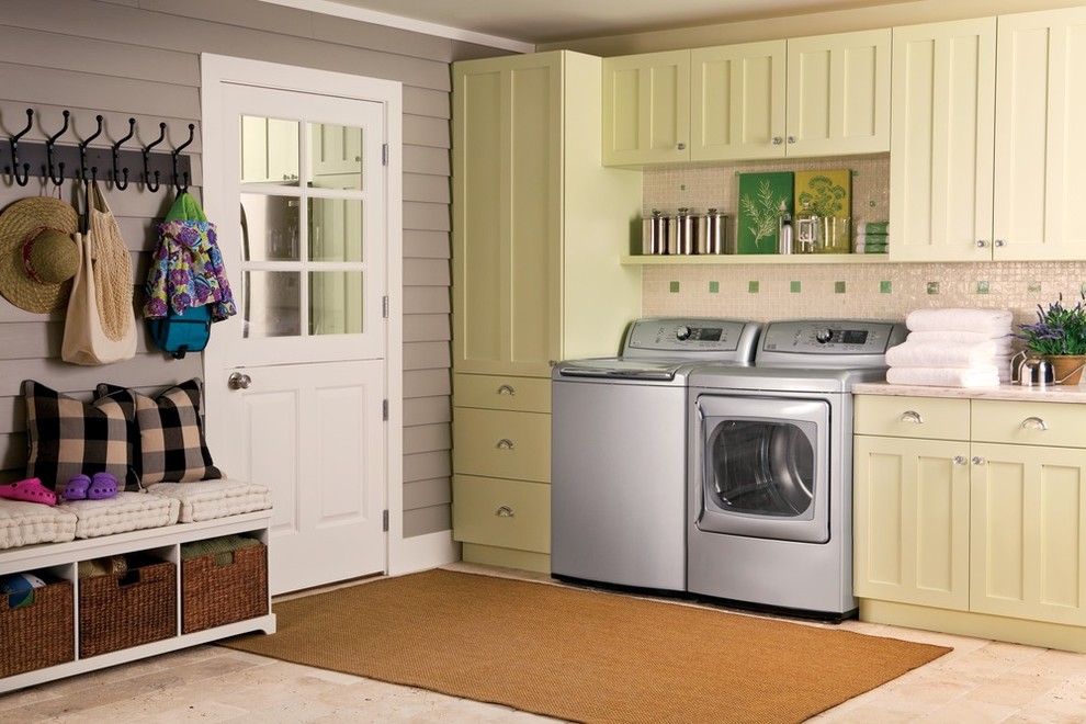 Large traditional single-wall utility room in New York with shaker cabinets, green cabinets, marble benchtops, white walls, ceramic floors, a side-by-side washer and dryer and beige floor.