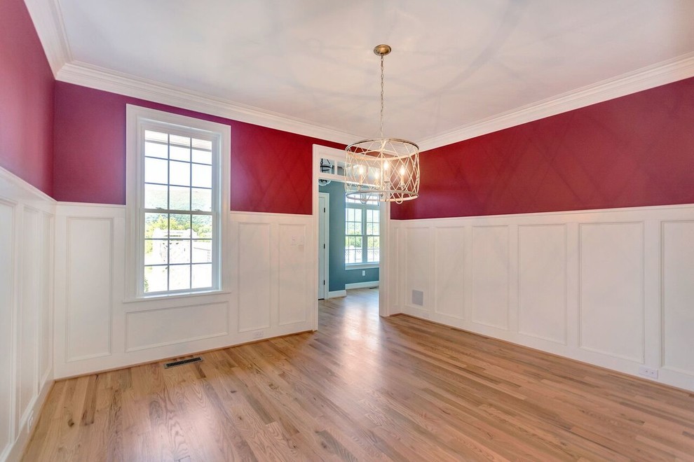 Country dining room in San Diego with red walls, medium hardwood floors and no fireplace.