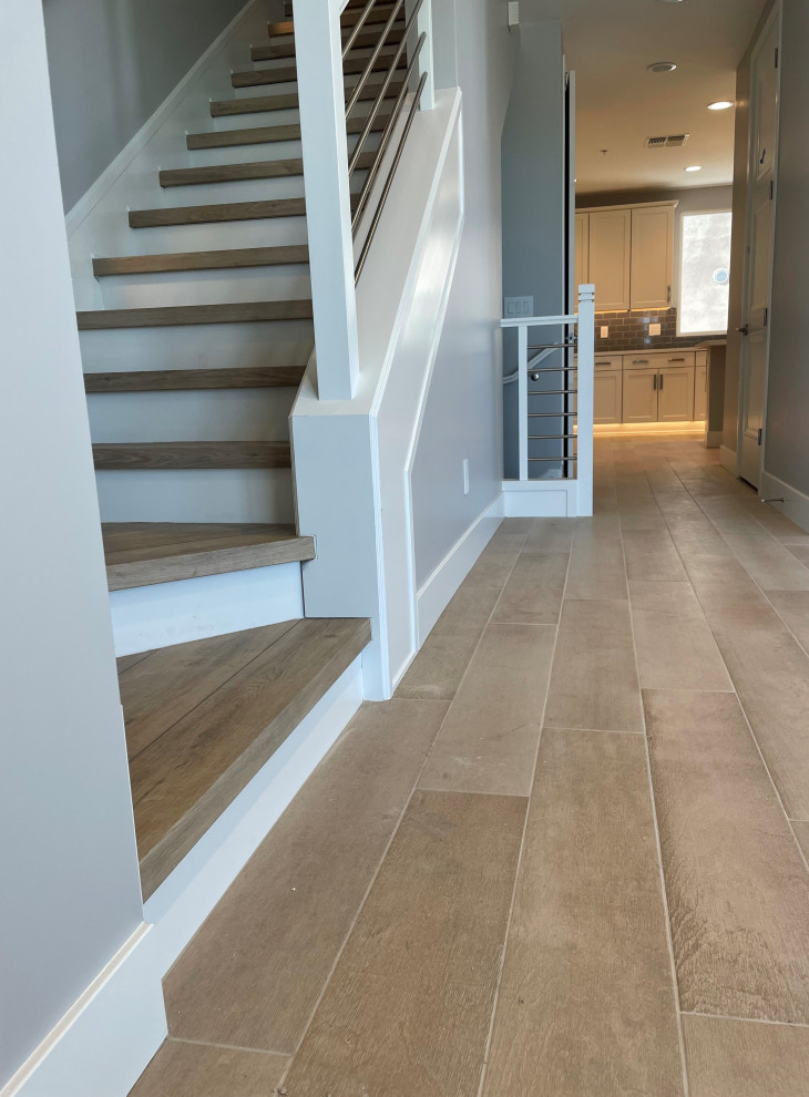 Example of a mid-sized transitional wooden l-shaped staircase design in Phoenix with wooden risers