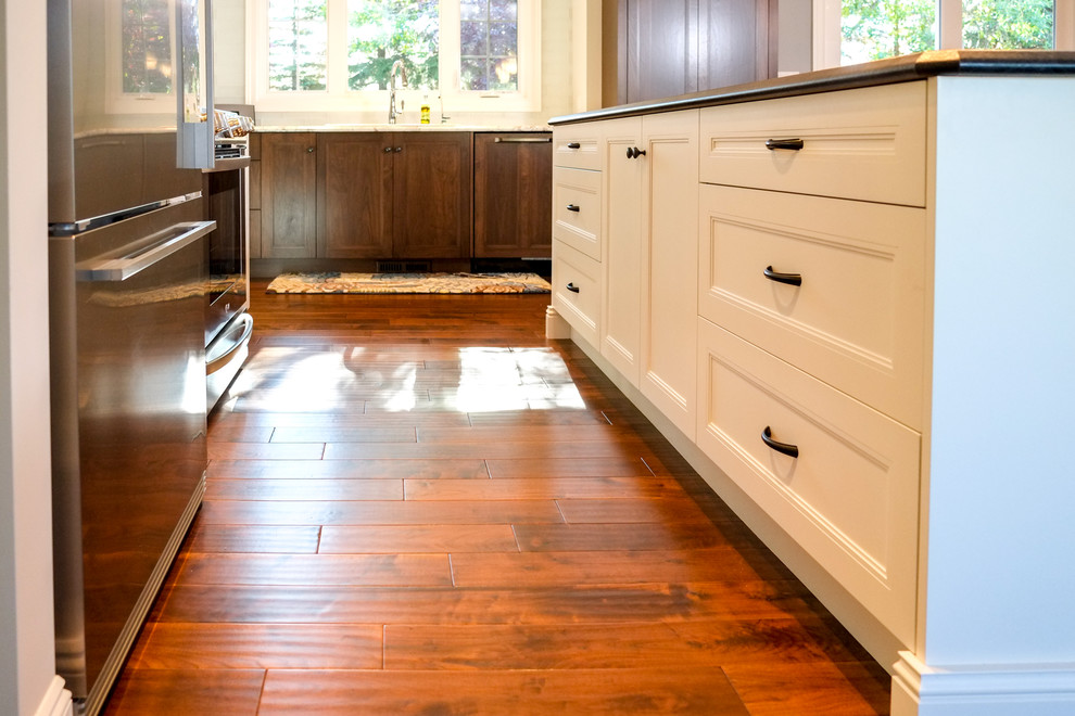 Example of a mid-sized transitional medium tone wood floor eat-in kitchen design in Calgary with a drop-in sink, recessed-panel cabinets, medium tone wood cabinets, laminate countertops, blue backsplash, glass tile backsplash, stainless steel appliances and an island