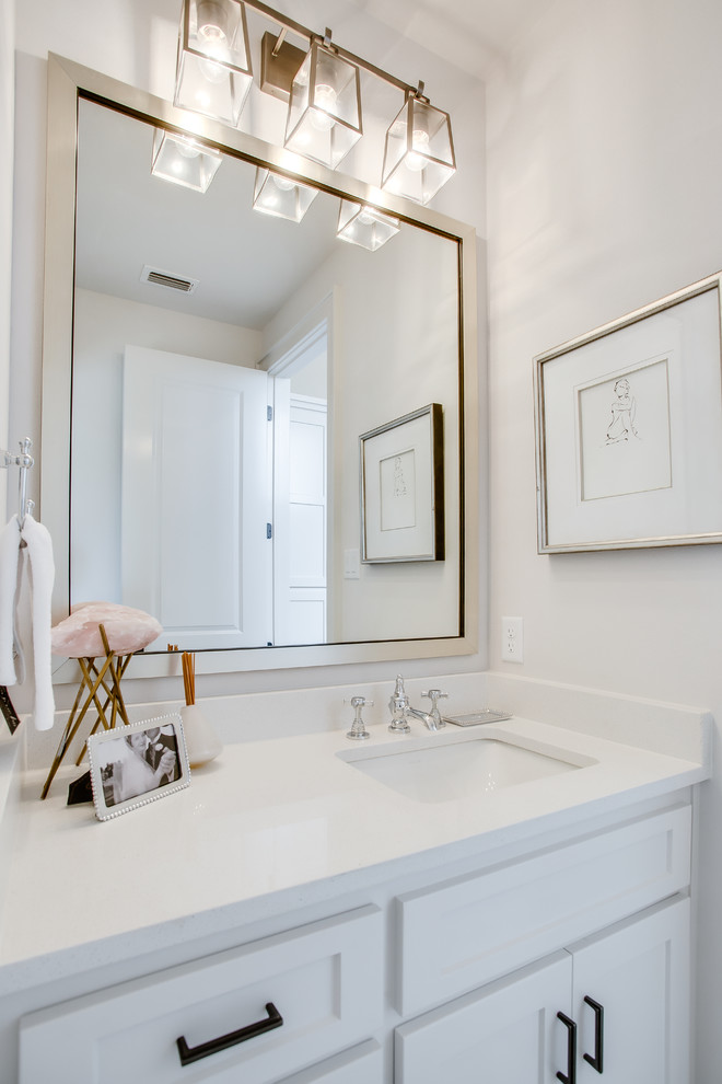 This is an example of a mid-sized traditional 3/4 bathroom in Austin with shaker cabinets, white cabinets, white tile, subway tile, an undermount sink, engineered quartz benchtops, white floor, white benchtops, an alcove tub and a shower/bathtub combo.