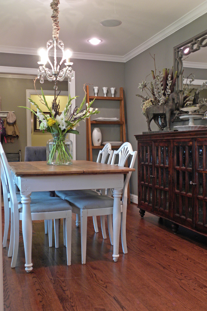 This is an example of an eclectic dining room in Dallas with grey walls and dark hardwood floors.
