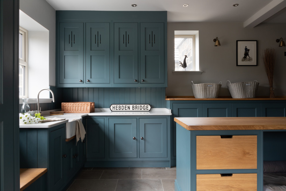 Inspiration for a large traditional open plan kitchen in Manchester with an integrated sink, shaker cabinets, black cabinets, quartzite benchtops, metallic splashback, mirror splashback, stainless steel appliances, limestone floors, multiple islands, grey floor, white benchtop and coffered.