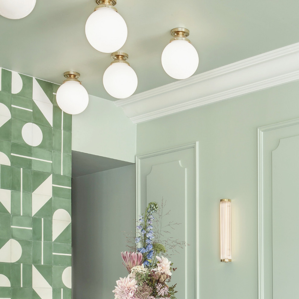 Inspiration for a mid-sized midcentury dining room in Paris with green walls and grey floor.