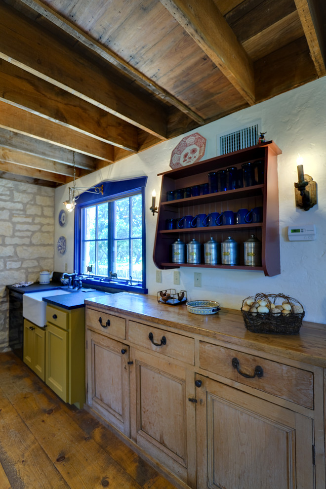 Kitchen - mid-sized rustic single-wall medium tone wood floor kitchen idea in Austin with a farmhouse sink