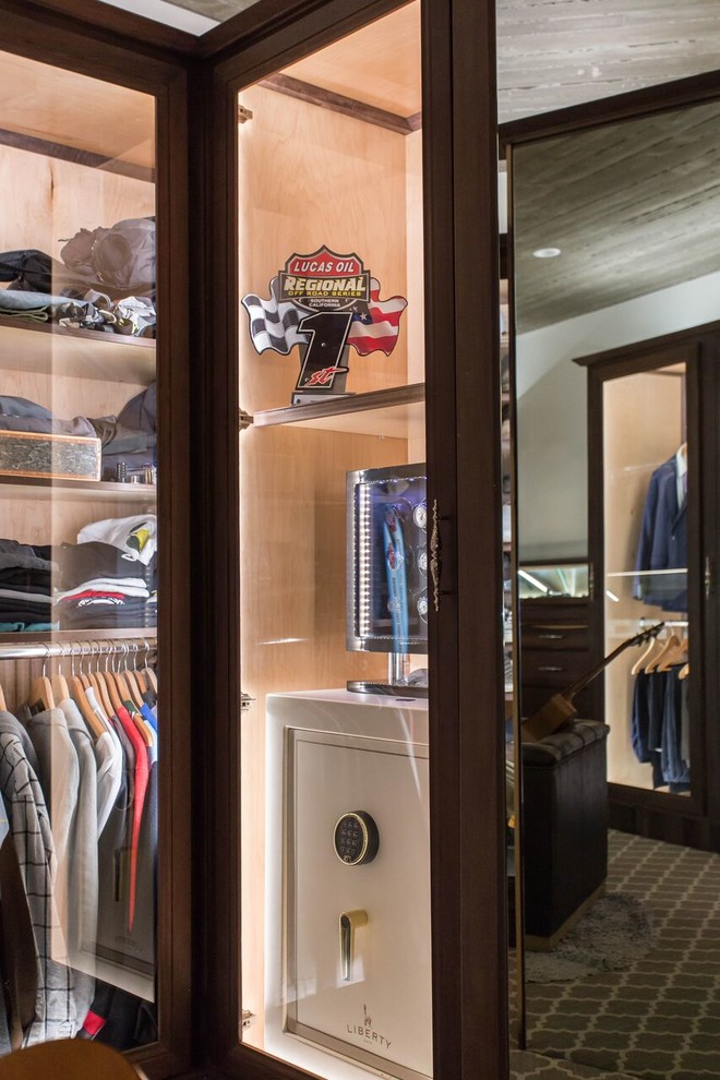 Design ideas for a large modern gender-neutral walk-in wardrobe in San Diego with raised-panel cabinets, dark wood cabinets, carpet and grey floor.