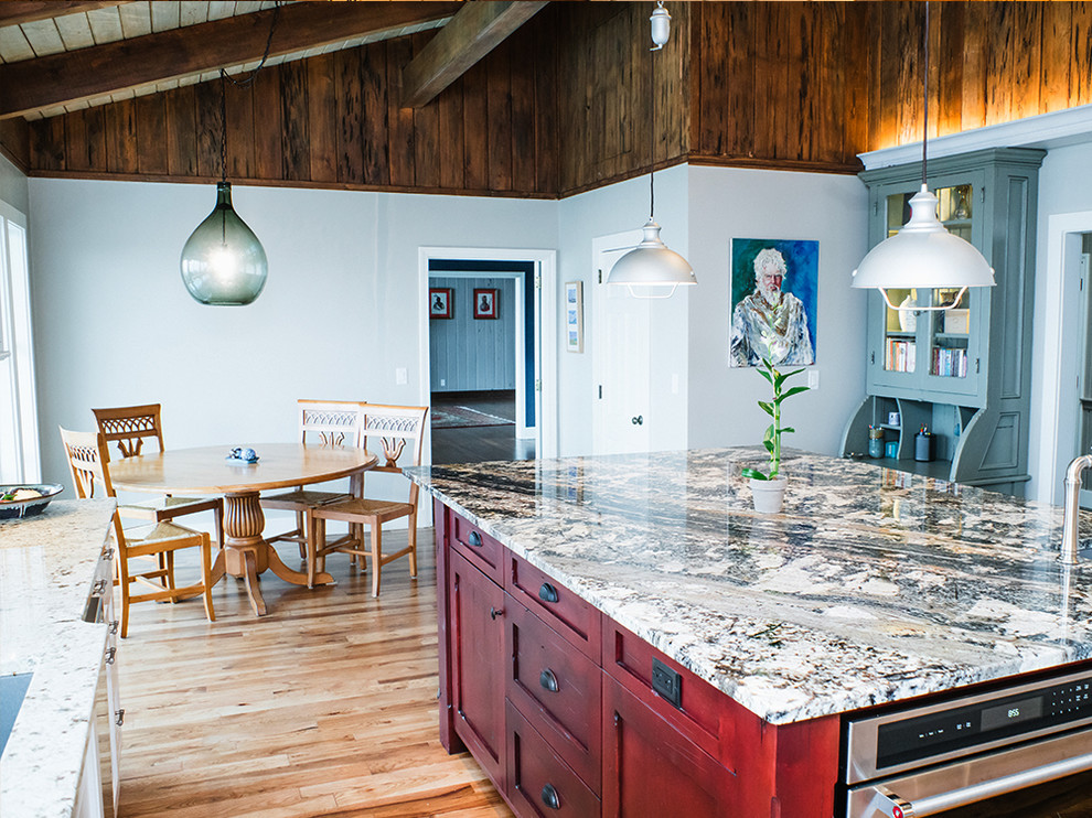 Eat-in kitchen - large transitional u-shaped medium tone wood floor eat-in kitchen idea with an undermount sink, white cabinets, granite countertops, white backsplash, ceramic backsplash, stainless steel appliances, an island and flat-panel cabinets
