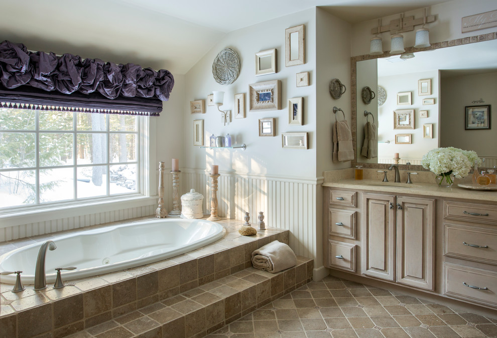 Design ideas for a large traditional bathroom in Portland Maine with an undermount sink, raised-panel cabinets, light wood cabinets, a drop-in tub, beige tile and beige walls.