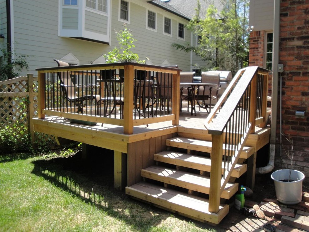 Example of a large mountain style backyard balcony deck design in Detroit with no cover