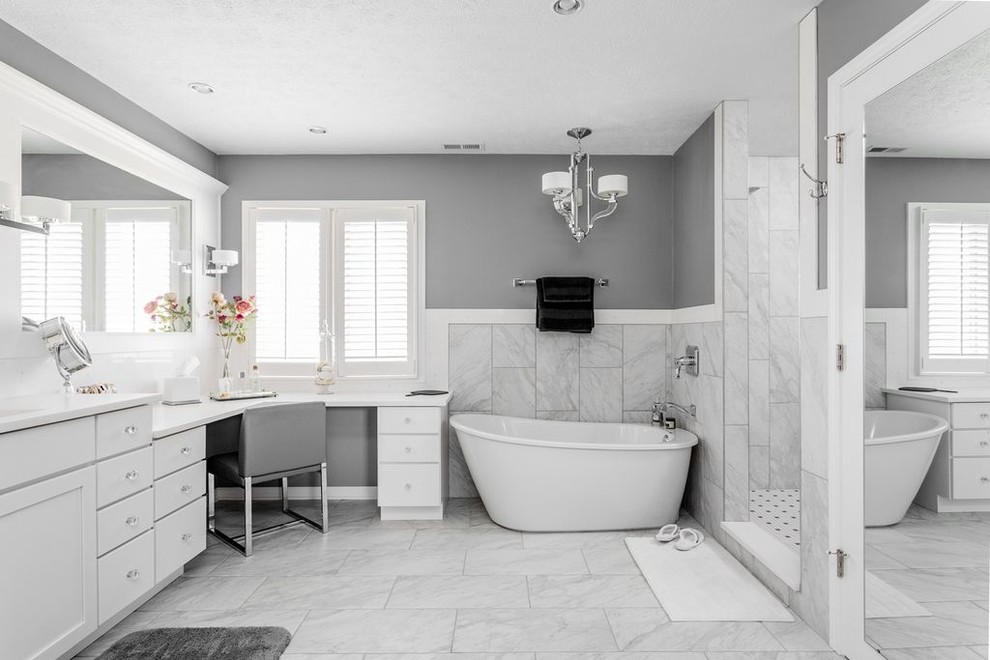 Photo of a large transitional master bathroom in Indianapolis with recessed-panel cabinets, white cabinets, gray tile, porcelain tile, grey walls, porcelain floors and engineered quartz benchtops.