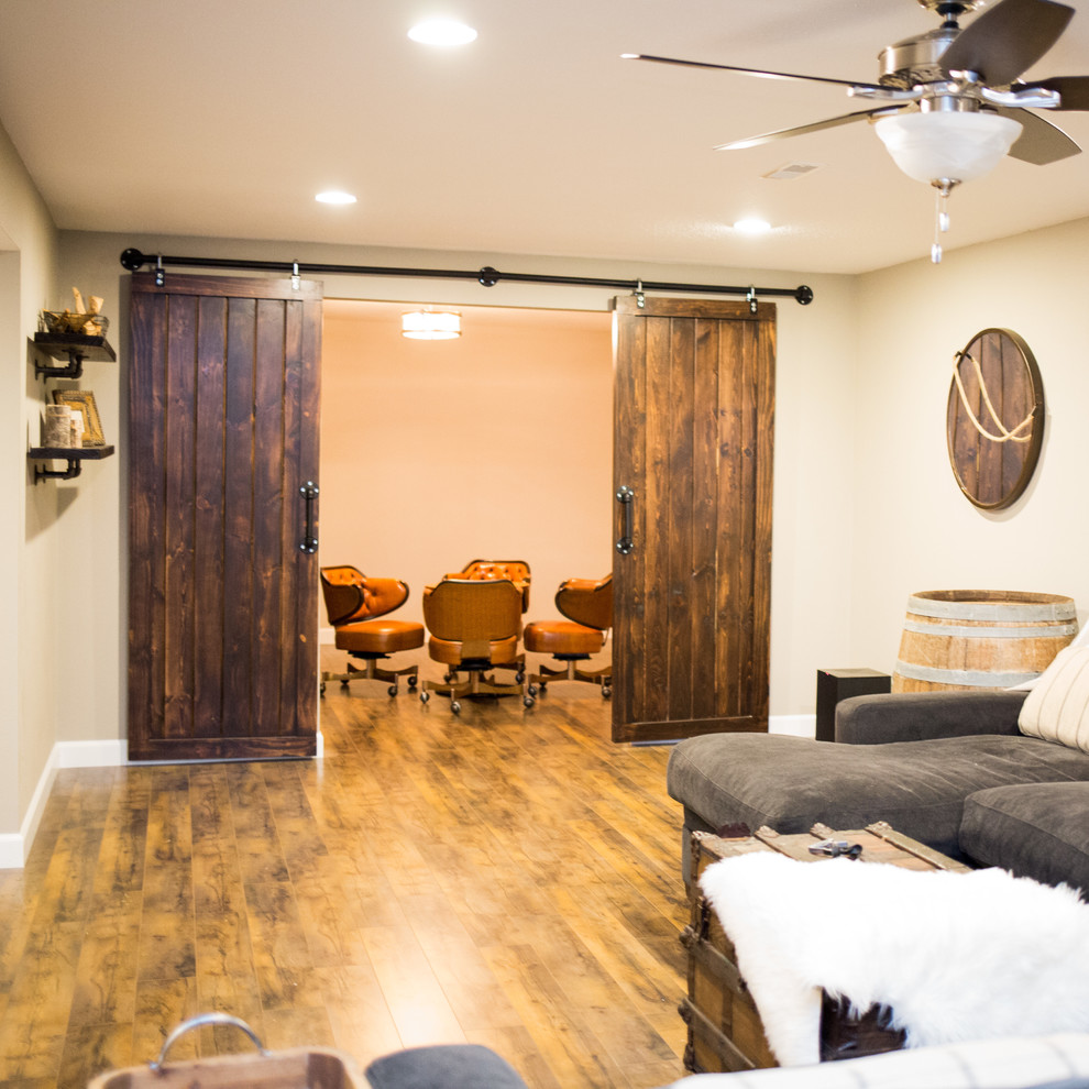 Inspiration for a mid-sized rustic underground medium tone wood floor basement remodel in St Louis with beige walls and no fireplace