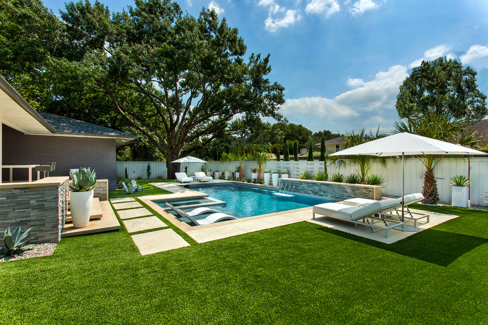 Mid-sized midcentury backyard rectangular lap pool in Dallas with a hot tub and concrete pavers.