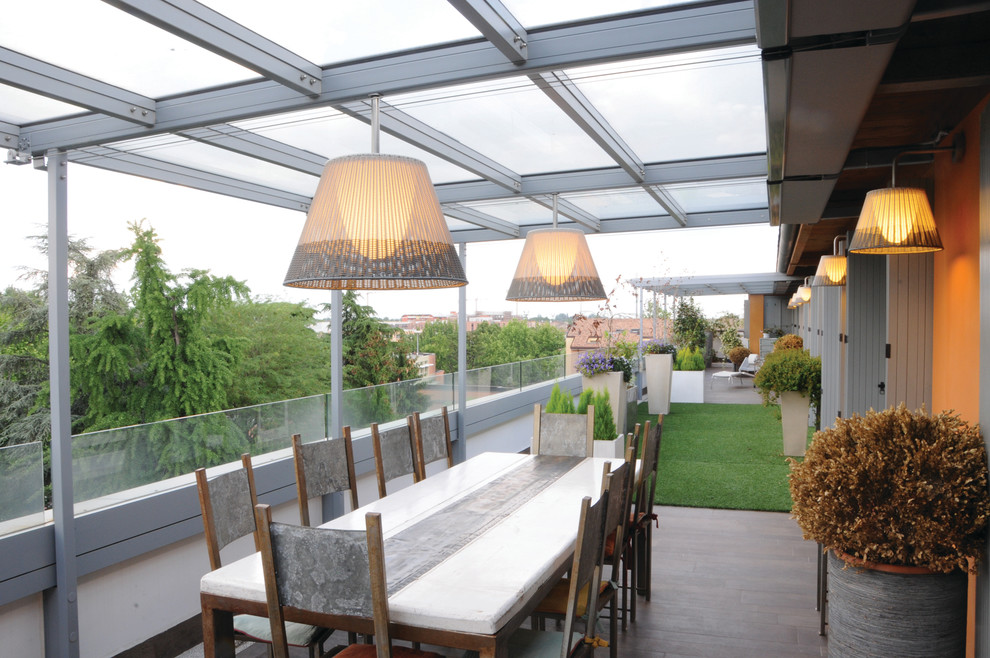 Inspiration for a large contemporary balcony in Bologna with a pergola.