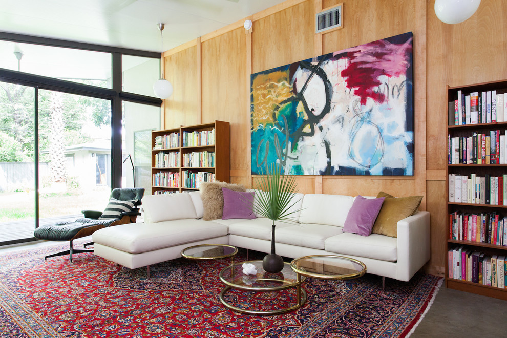 Inspiration for a midcentury living room in Austin with a library, brown walls, linoleum floors, no fireplace and no tv.