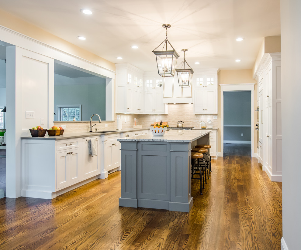 This is an example of a mid-sized traditional u-shaped separate kitchen in Boston with an undermount sink, shaker cabinets, stainless steel appliances, dark hardwood floors, with island, white cabinets, granite benchtops, beige splashback and porcelain splashback.