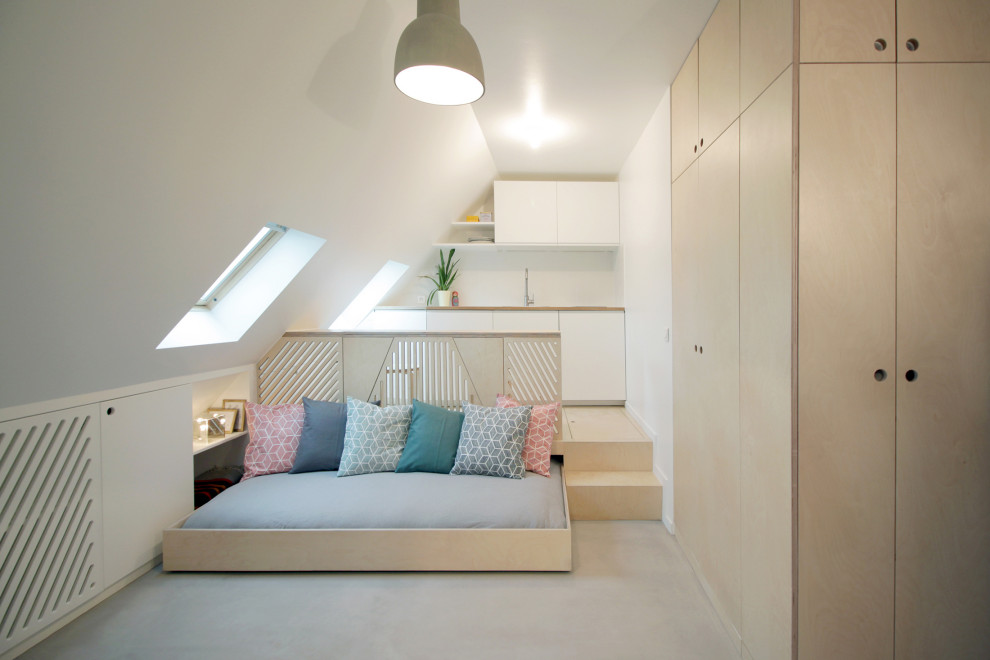 Ispirazione per un piccolo soggiorno design stile loft con pareti bianche, pavimento in cemento, TV nascosta e pavimento grigio
