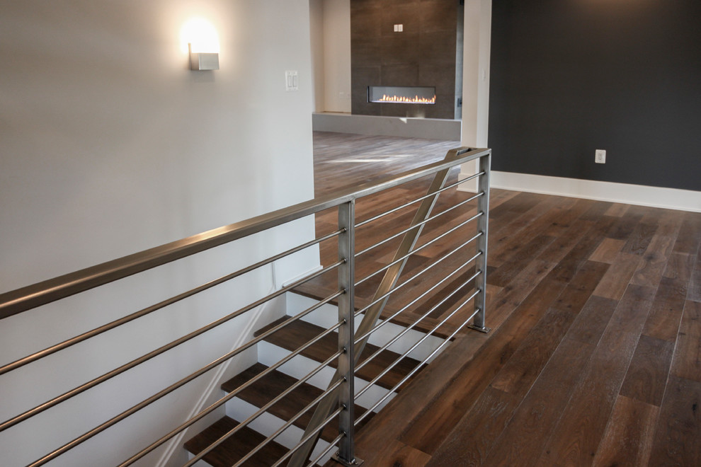 Inspiration for a large contemporary wood floating staircase in DC Metro with metal railing.