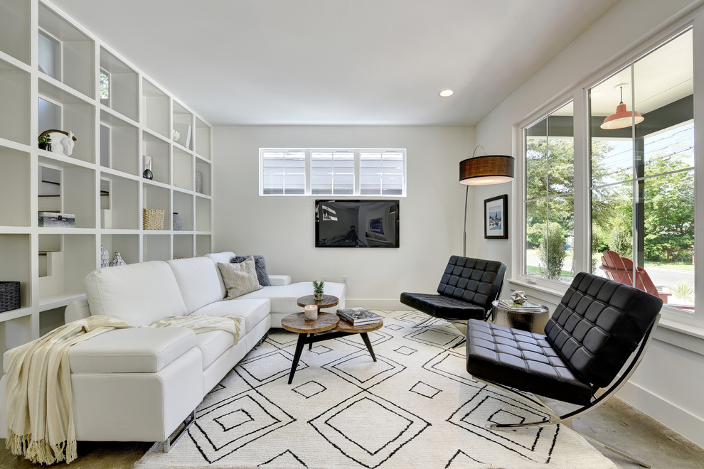 Small minimalist open concept concrete floor family room photo in Austin with white walls, no fireplace and a wall-mounted tv