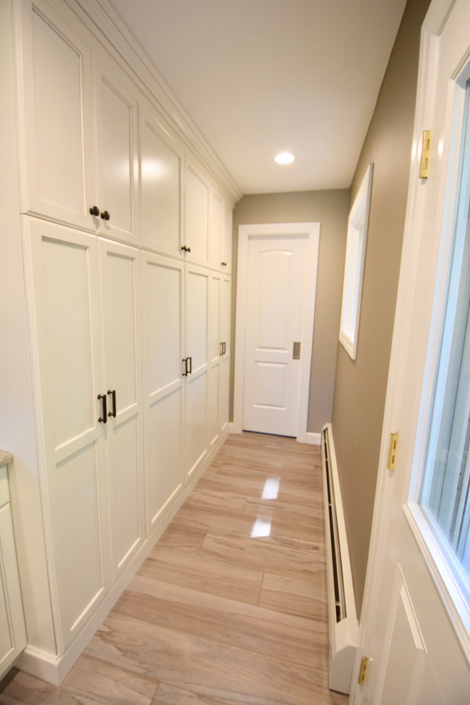 Huge transitional vinyl floor and brown floor eat-in kitchen photo with a farmhouse sink, recessed-panel cabinets, white cabinets, quartz countertops, multicolored backsplash, ceramic backsplash, stainless steel appliances, an island and multicolored countertops