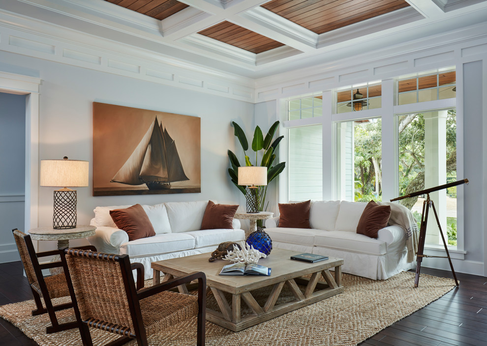This is an example of a large beach style formal enclosed living room in Miami with grey walls, dark hardwood floors, no fireplace and no tv.