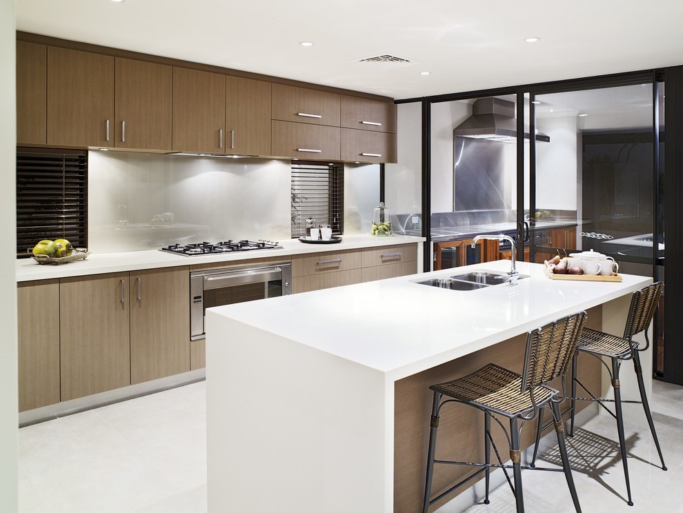 This is an example of a contemporary kitchen in Other with flat-panel cabinets, medium wood cabinets and with island.