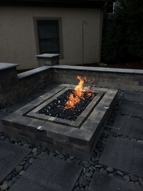 Design ideas for a large modern backyard patio in Chicago with a fire feature, natural stone pavers and no cover.
