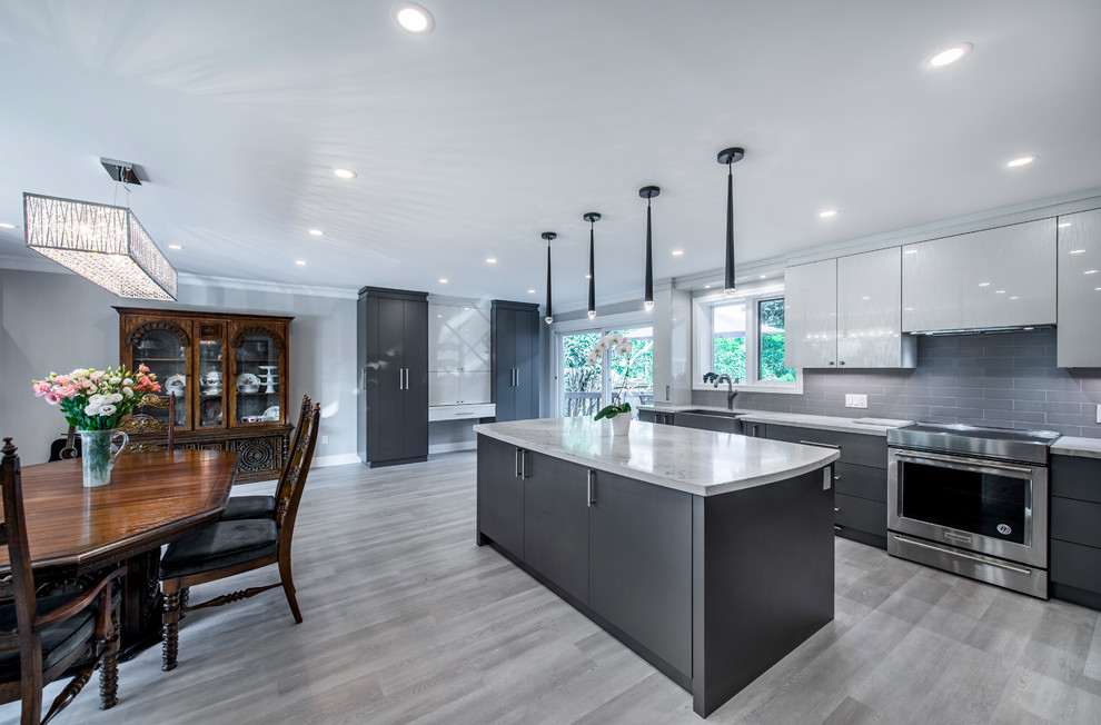 Inspiration for a large modern u-shaped eat-in kitchen in Toronto with a farmhouse sink, flat-panel cabinets, white cabinets, quartzite benchtops, grey splashback, subway tile splashback, stainless steel appliances, vinyl floors, with island, grey floor and white benchtop.