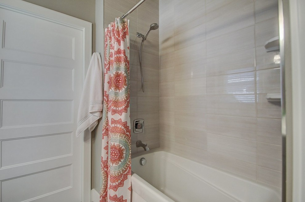 Alcove bathtub - mid-sized transitional 3/4 porcelain tile alcove bathtub idea with recessed-panel cabinets, gray cabinets, a two-piece toilet, gray walls, an undermount sink and solid surface countertops