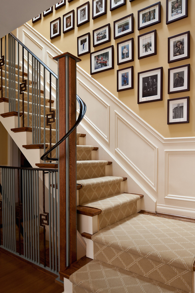 Large traditional wood l-shaped staircase in Toronto with painted wood risers.