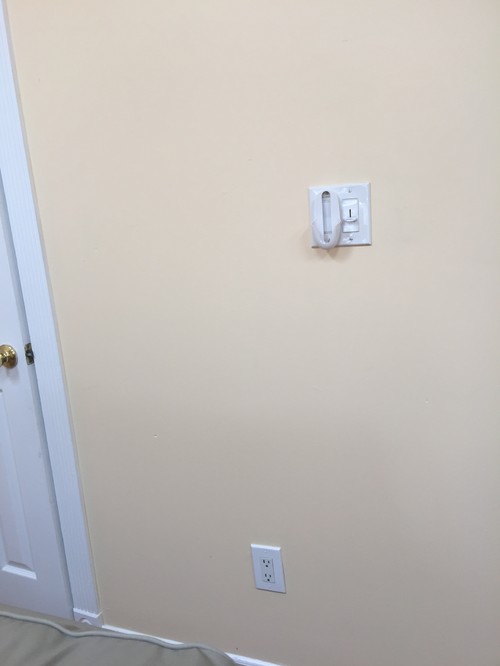 How do I hang pictures, art around light switches??