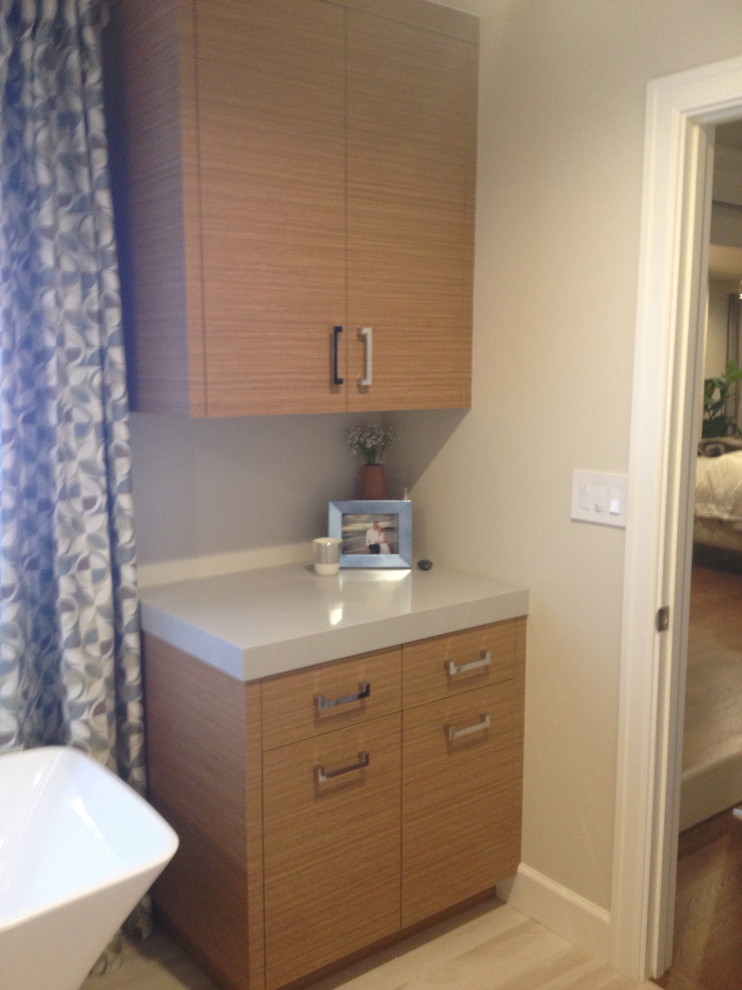 Freestanding bathtub - mid-sized transitional master blue tile and subway tile light wood floor and blue floor freestanding bathtub idea with flat-panel cabinets, distressed cabinets, beige walls, an undermount sink, solid surface countertops and a hinged shower door