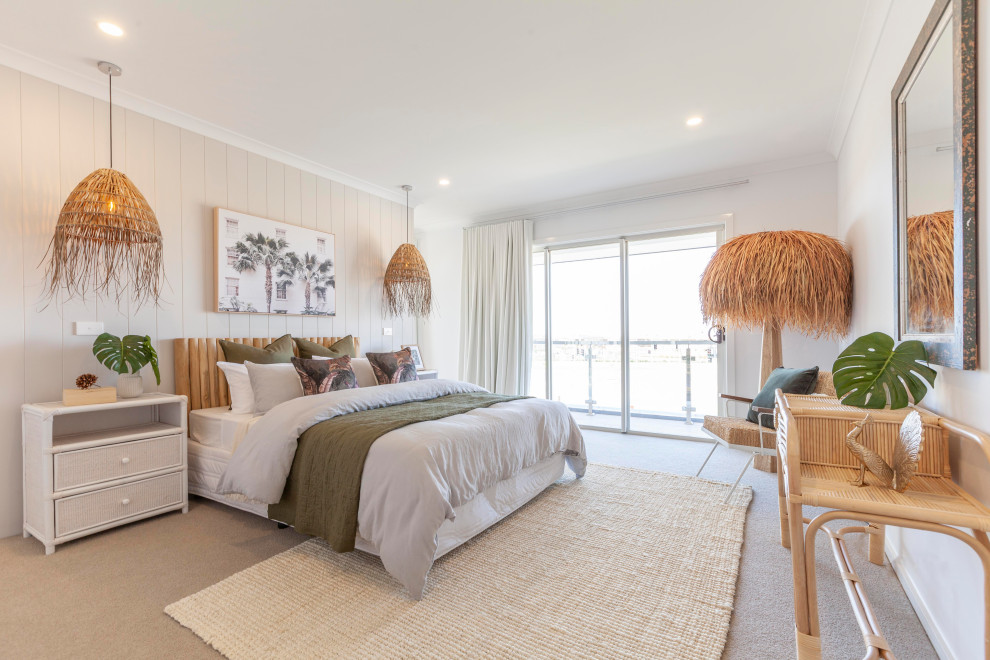 This is an example of a mid-sized tropical guest bedroom in Melbourne with beige walls, carpet, beige floor and panelled walls.