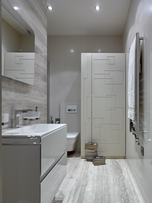 Inspiration for a mid-sized contemporary 3/4 bathroom in Moscow with flat-panel cabinets, white cabinets, an undermount tub, a wall-mount toilet, beige tile, travertine, beige walls, porcelain floors, a drop-in sink, beige floor, a sliding shower screen, a laundry, a single vanity and a floating vanity.