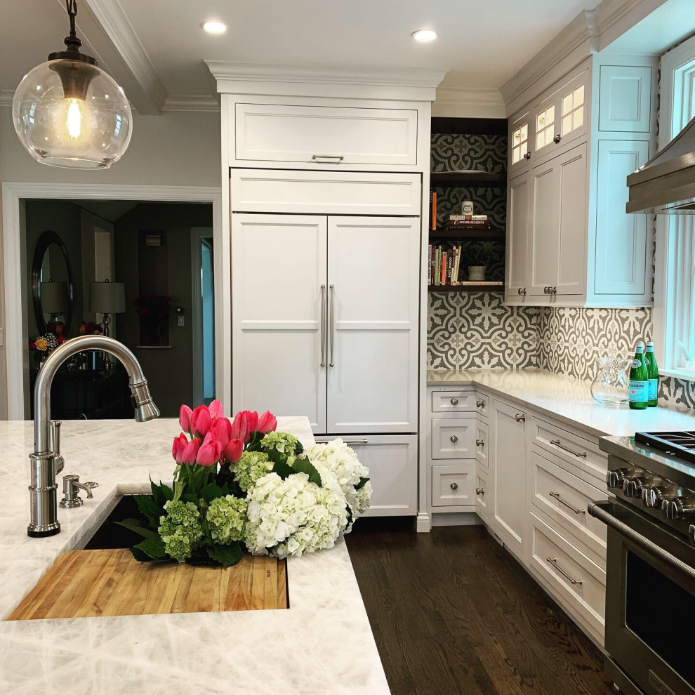 Large transitional l-shaped dark wood floor and brown floor open concept kitchen photo in Chicago with an integrated sink, recessed-panel cabinets, white cabinets, quartz countertops, cement tile backsplash, stainless steel appliances, an island and white countertops