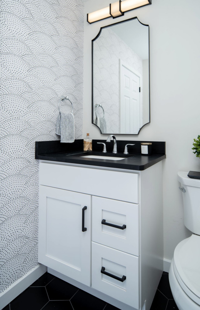 Photo of a medium sized modern cloakroom in Philadelphia with shaker cabinets, black cabinets, a two-piece toilet, black and white tiles, mosaic tiles, white walls, vinyl flooring, a submerged sink, engineered stone worktops, grey floors, turquoise worktops, a built in vanity unit and wallpapered walls.