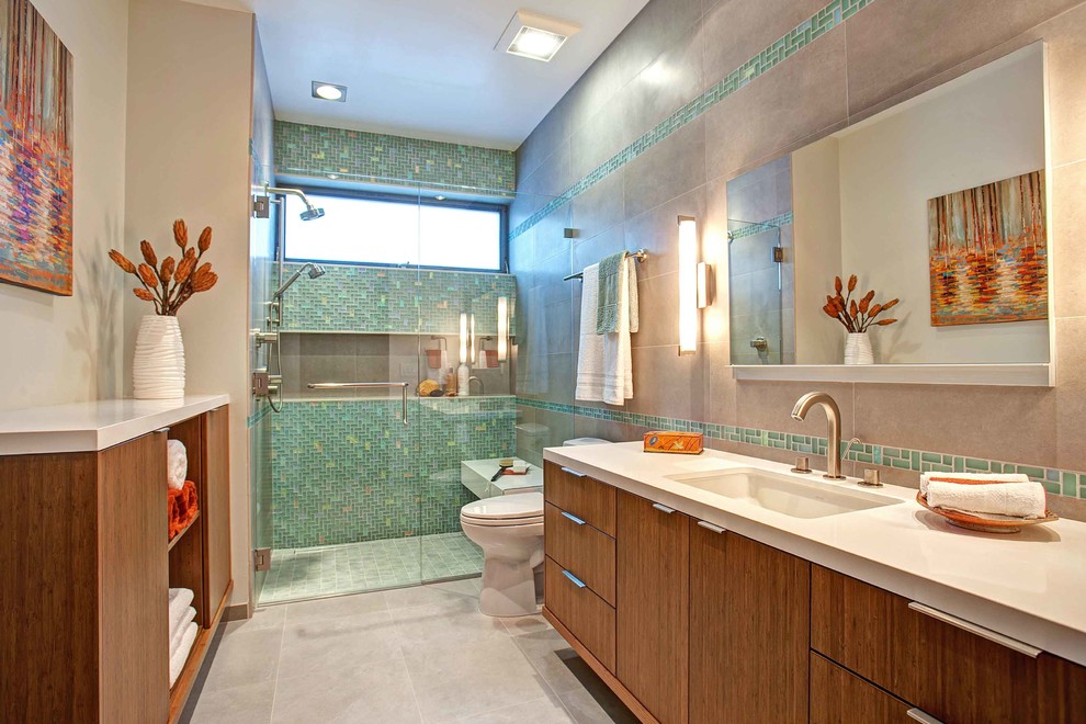 Design ideas for a contemporary bathroom in San Diego with an undermount sink, flat-panel cabinets, medium wood cabinets, a curbless shower, a two-piece toilet, green tile and glass tile.