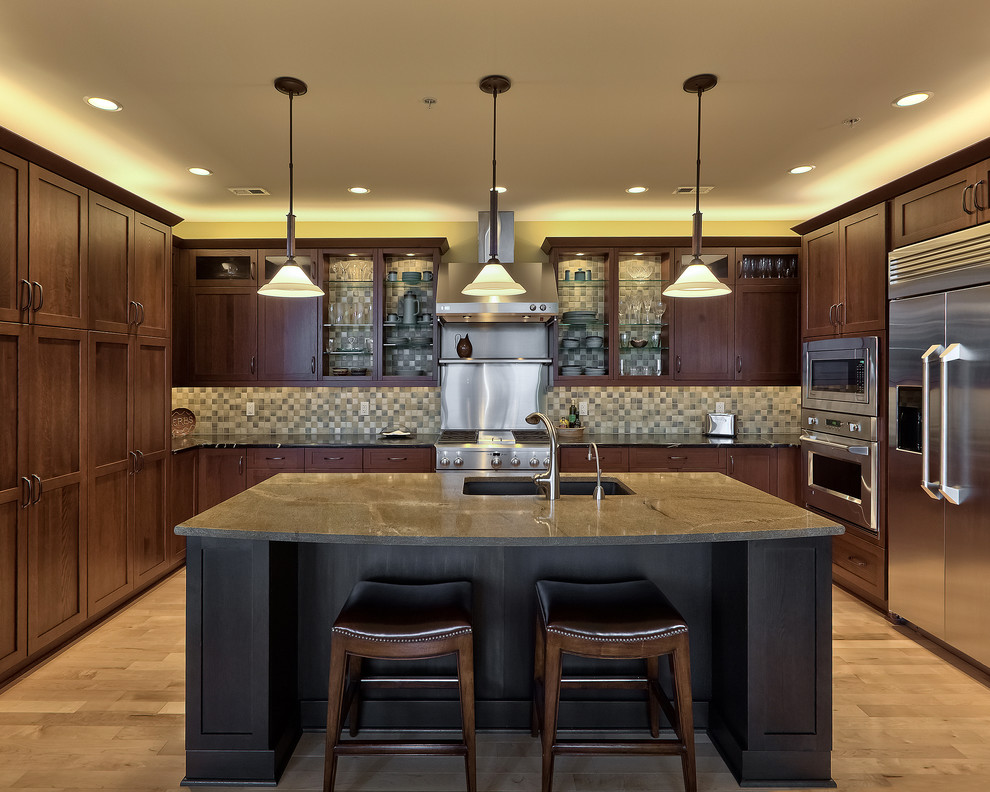 Eat-in kitchen - large transitional light wood floor eat-in kitchen idea in Omaha with a drop-in sink, shaker cabinets, medium tone wood cabinets, granite countertops, blue backsplash, ceramic backsplash, stainless steel appliances and an island