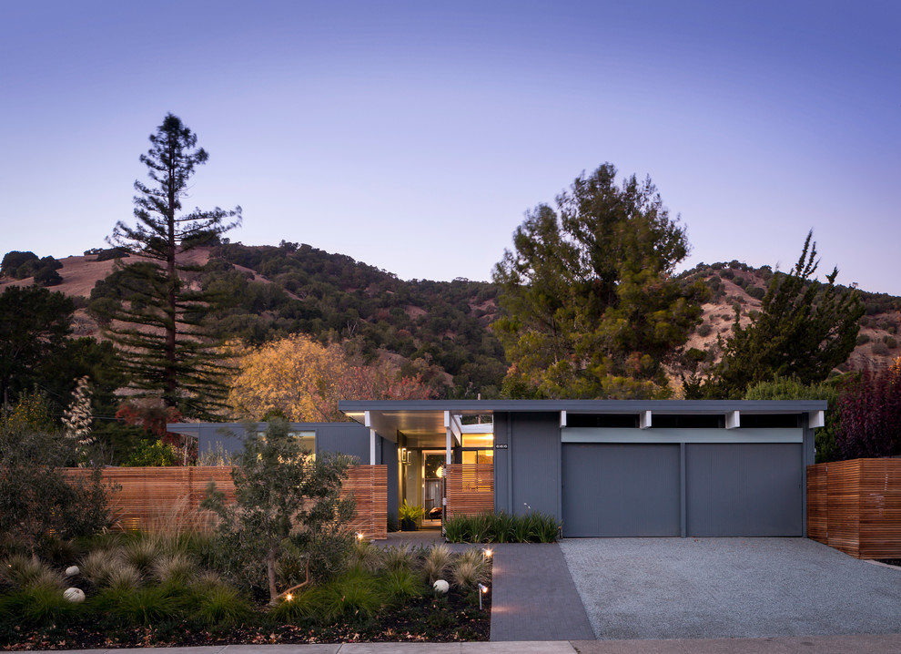 Example of a mid-sized 1960s gray one-story wood exterior home design in San Francisco with a mixed material roof and a gray roof