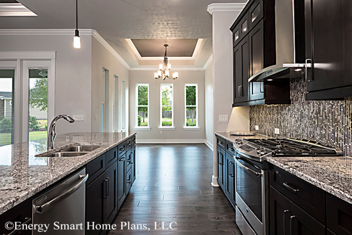 Example of a mid-sized transitional galley dark wood floor eat-in kitchen design in Miami with an undermount sink, recessed-panel cabinets, dark wood cabinets, granite countertops, multicolored backsplash, ceramic backsplash, stainless steel appliances and a peninsula